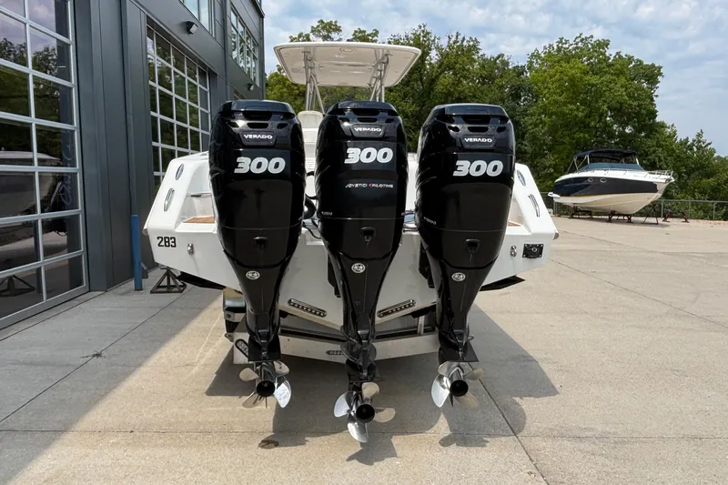 Slide: The Image of 2014 Cigarette 39 GTS boat with triple 300 Verado engines, docked outdoors. - 4