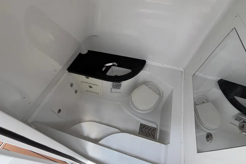 Slide: The Image of 2014 Cigarette 39 GTS boat bathroom with toilet, sink, and mirror. - 40