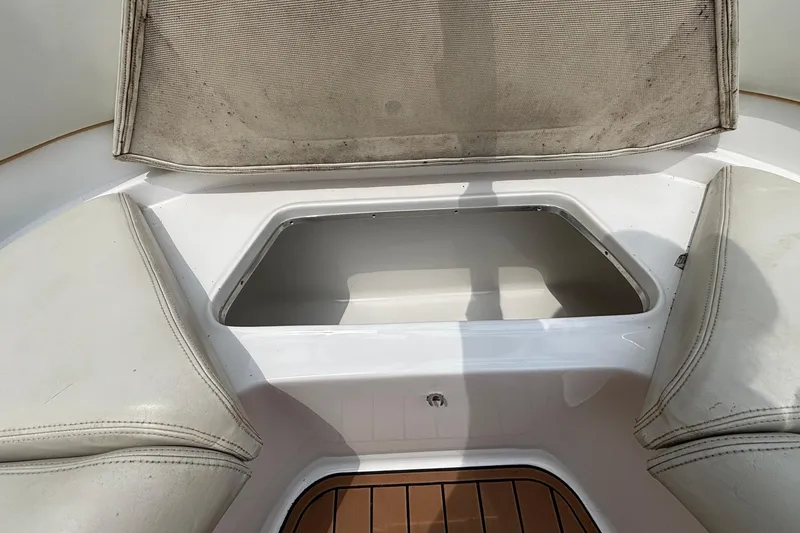 Slide: The Image of Open storage compartment on 2014 Cigarette 39 GTS boat with cushioned seating. - 42