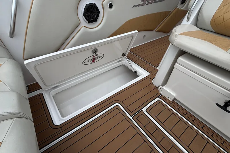 Slide: The Image of 2014 Cigarette 39 GTS boat interior with open storage compartment and cushioned seating. - 46