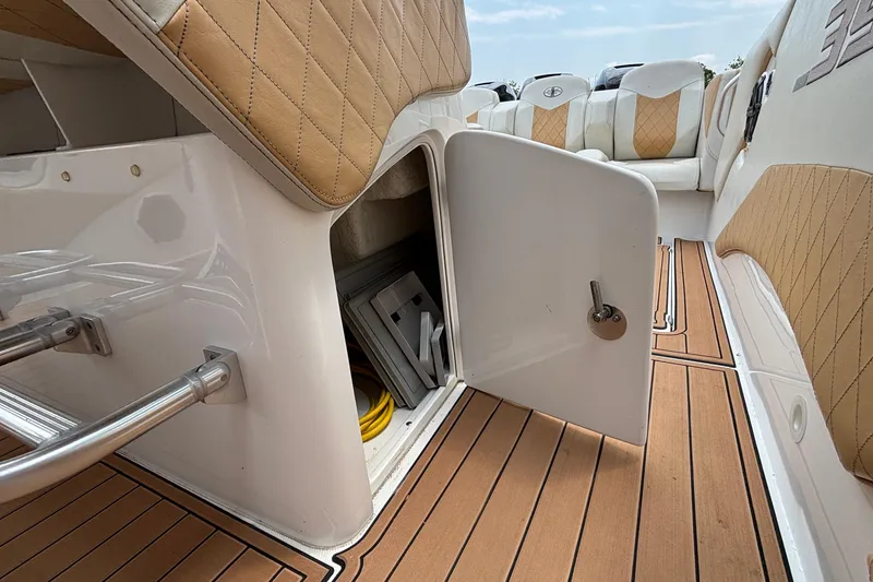 Slide: The Image of 2014 Cigarette 39 GTS boat interior with open storage compartment and cushioned seating. - 48