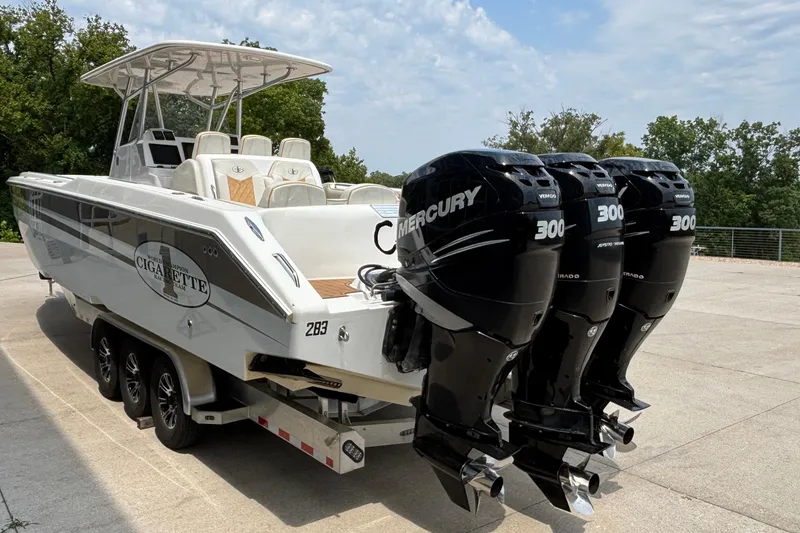 Slide: The Image of 2014 Cigarette 39 GTS boat with triple Mercury 300 engines on a trailer. - 5