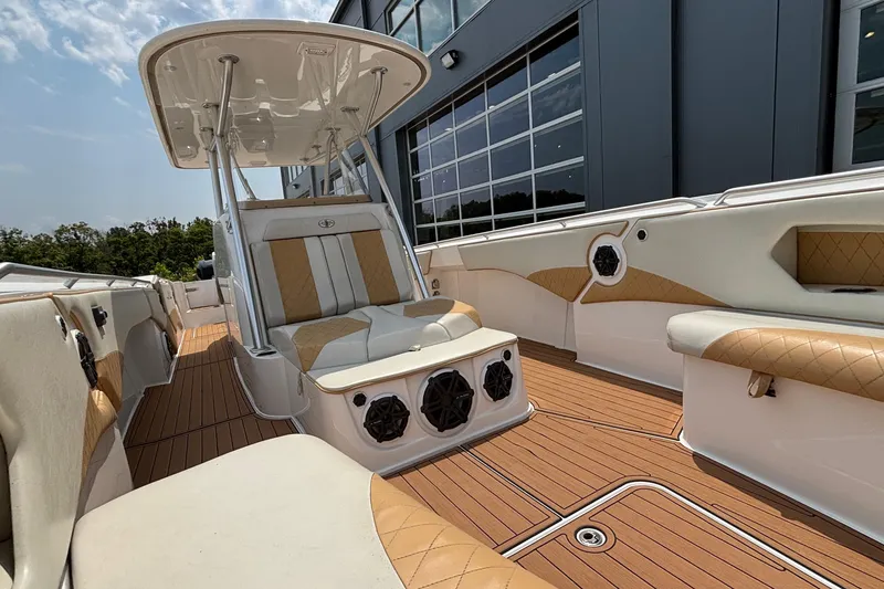 Slide: The Image of 2014 Cigarette 39 GTS boat interior with tan and white seating, wood flooring, and modern design. - 31