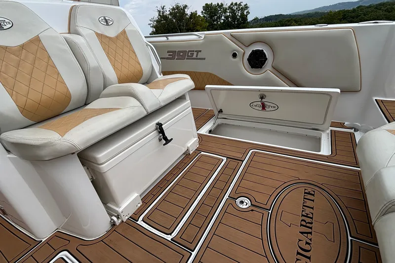 Slide: The Image of 2014 Cigarette 39 GTS boat interior with tan leather seats and wood-patterned flooring. - 47