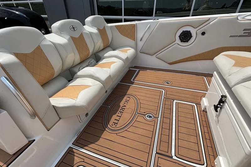 Slide: The Image of 2014 Cigarette 39 GTS boat interior with tan and white seating, teak-style flooring. - 9