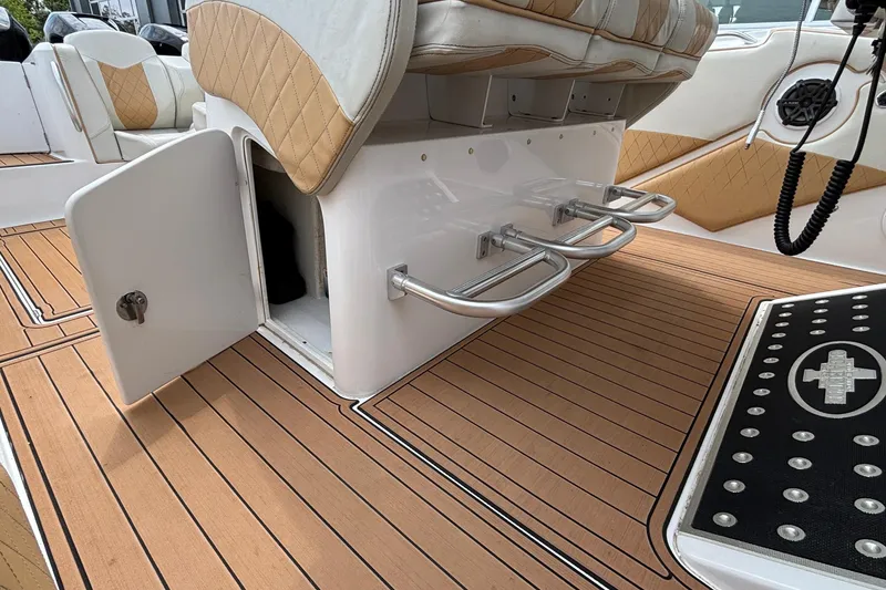 Slide: The Image of 2014 Cigarette 39 GTS boat interior with open storage, cushioned seats, and teak flooring. - 45