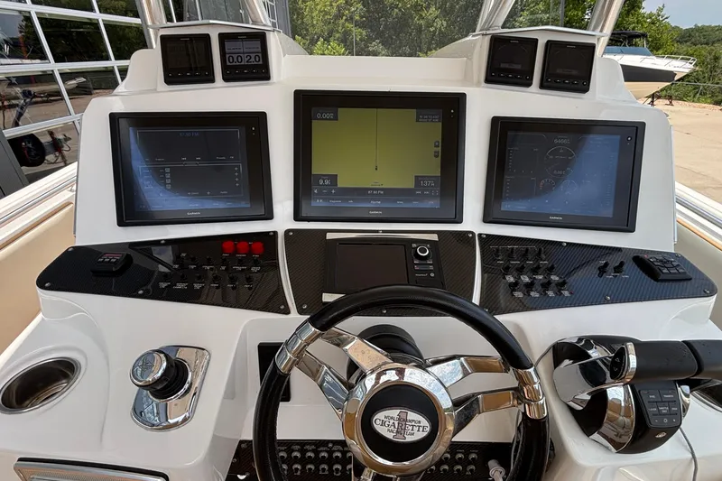 Slide: The Image of 2014 Cigarette 39 GTS boat dashboard with advanced navigation and control systems. - 21