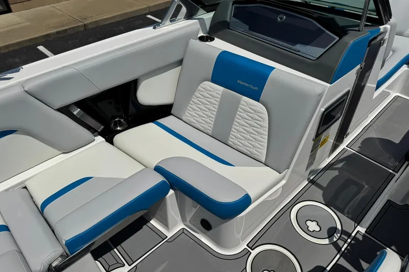 Slide: The Image of 2020 MasterCraft X24 boat interior with blue and white seating, showcasing modern design. - 10