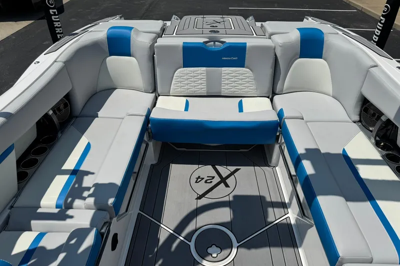 Slide: The Image of 2020 MasterCraft X24 boat interior with blue and white seating, showcasing luxury design. - 12
