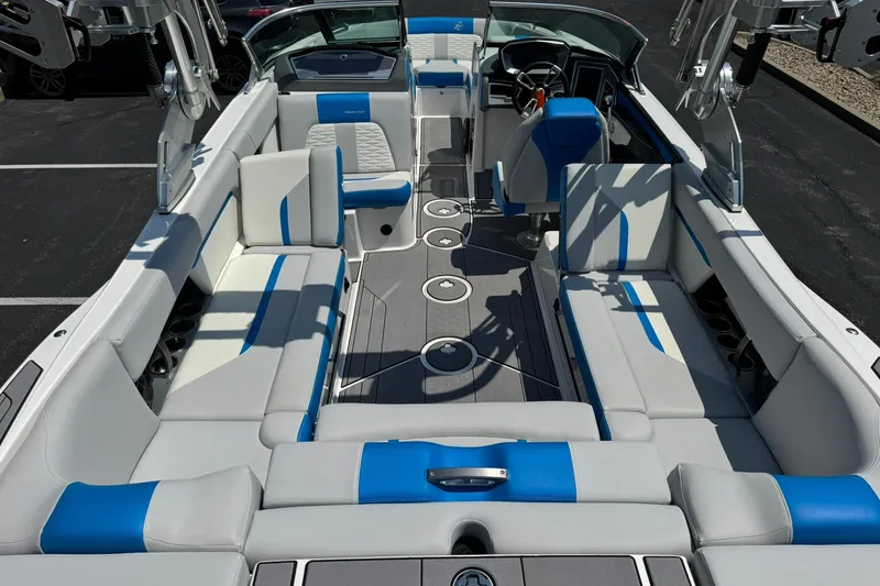 Slide: The Image of 2020 MasterCraft X24 boat interior with blue and white seating, showcasing modern design. - 13