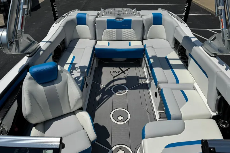 Slide: The Image of 2020 MasterCraft X24 boat interior with blue and white seating, showcasing luxury design. - 8
