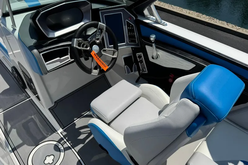 Slide: The Image of 2020 MasterCraft X24 boat interior with steering wheel and captain's seat. - 9