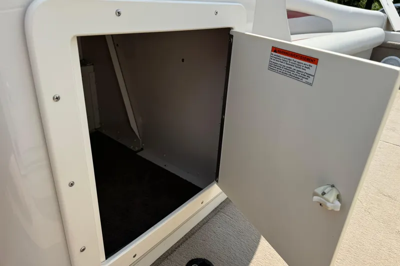 Slide: The Image of Open storage compartment on 2004 Princecraft Vacanza 250 I/O boat. - 11