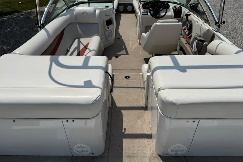 Slide: The Image of 2004 Princecraft Vacanza 250 I/O boat interior with white seating and steering console. - 12