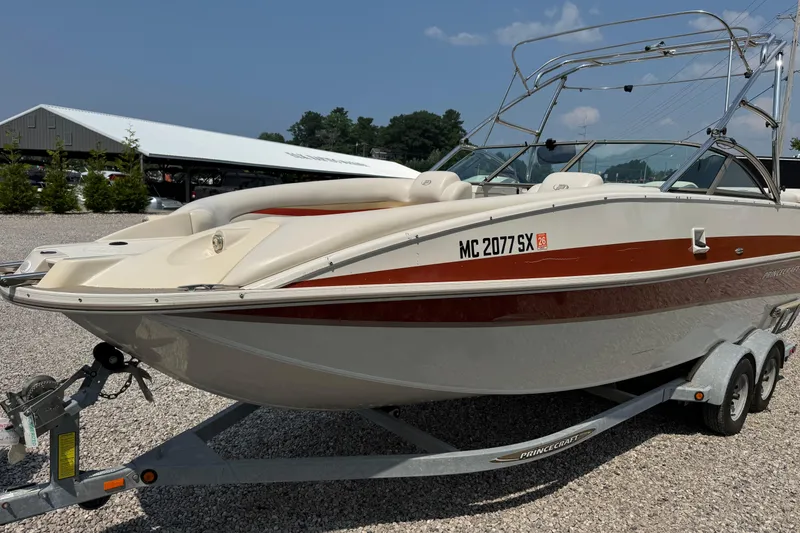 Slide: The Image of 2004 Princecraft Vacanza 250 I/O boat on trailer, parked outdoors. - 3
