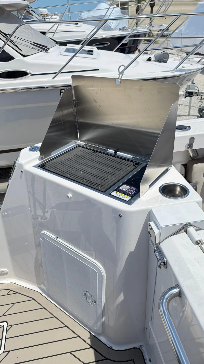 Slide: The Image of Outdoor grill on 2026 Cutwater C-288 Coupe boat deck, featuring stainless steel finish. - 14