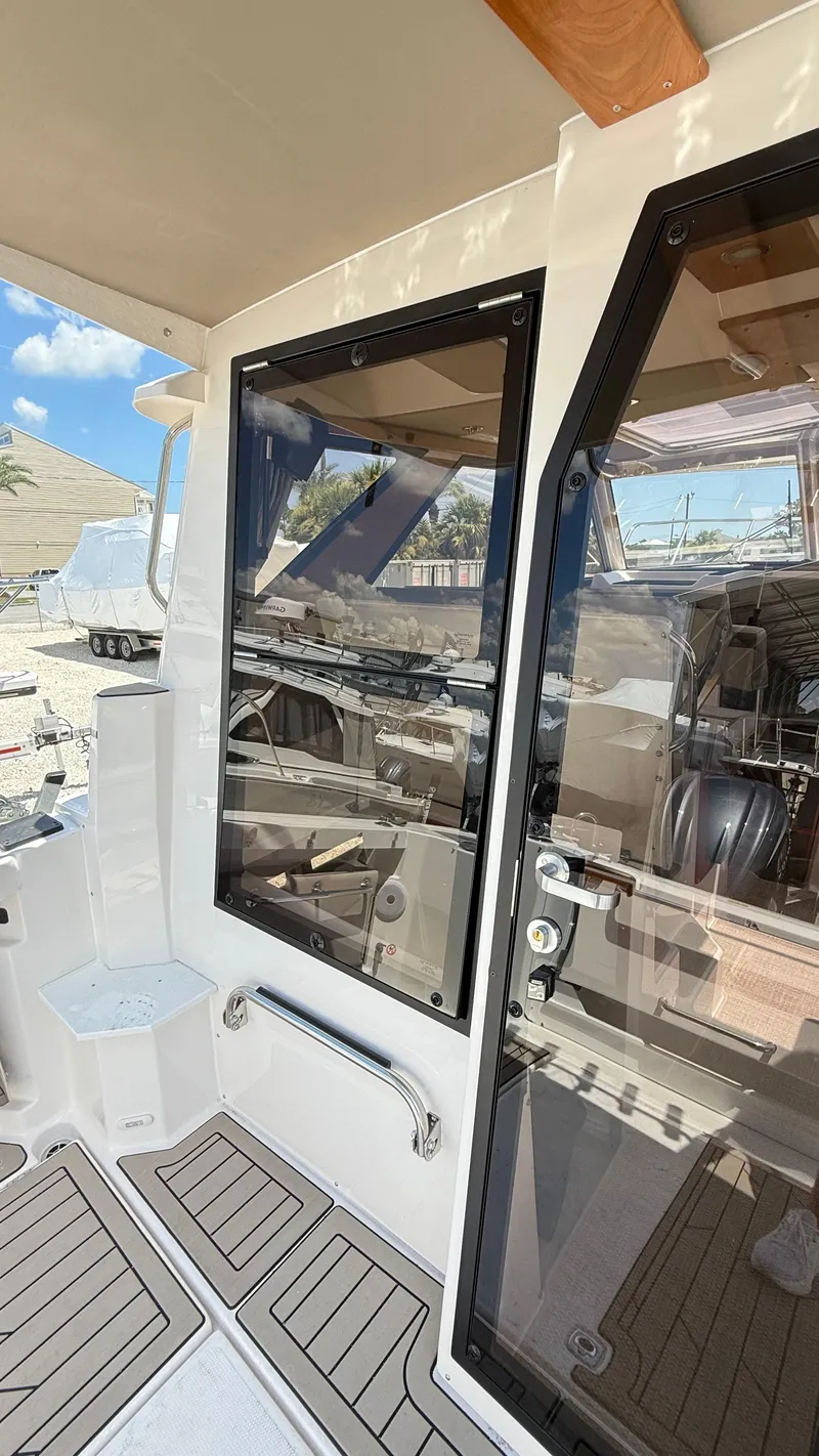 Slide: The Image of 2026 Cutwater C-288 Coupe boat interior with sleek glass doors and modern design. - 16