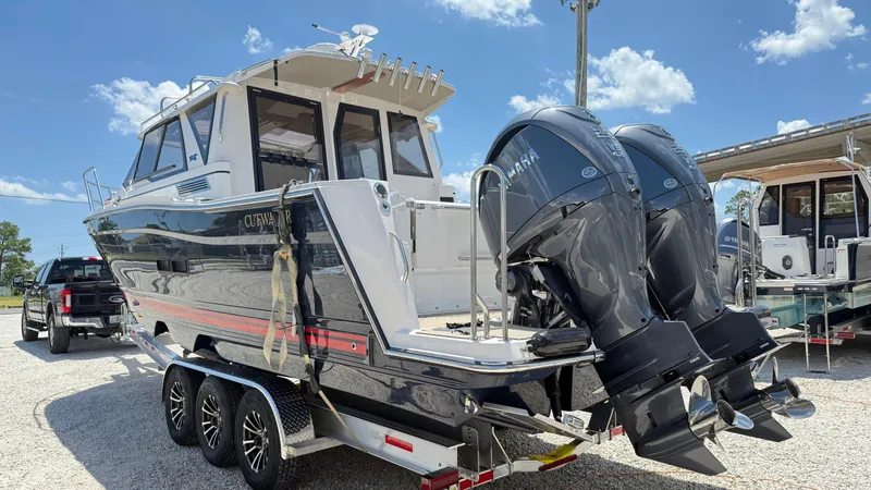Slide: The Image of 2026 Cutwater C-288 Coupe boat with dual Yamaha outboard engines on a trailer. - 2
