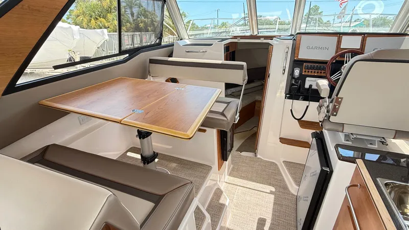 Slide: The Image of Interior of 2026 Cutwater C-288 Coupe boat with dining area and helm. - 24