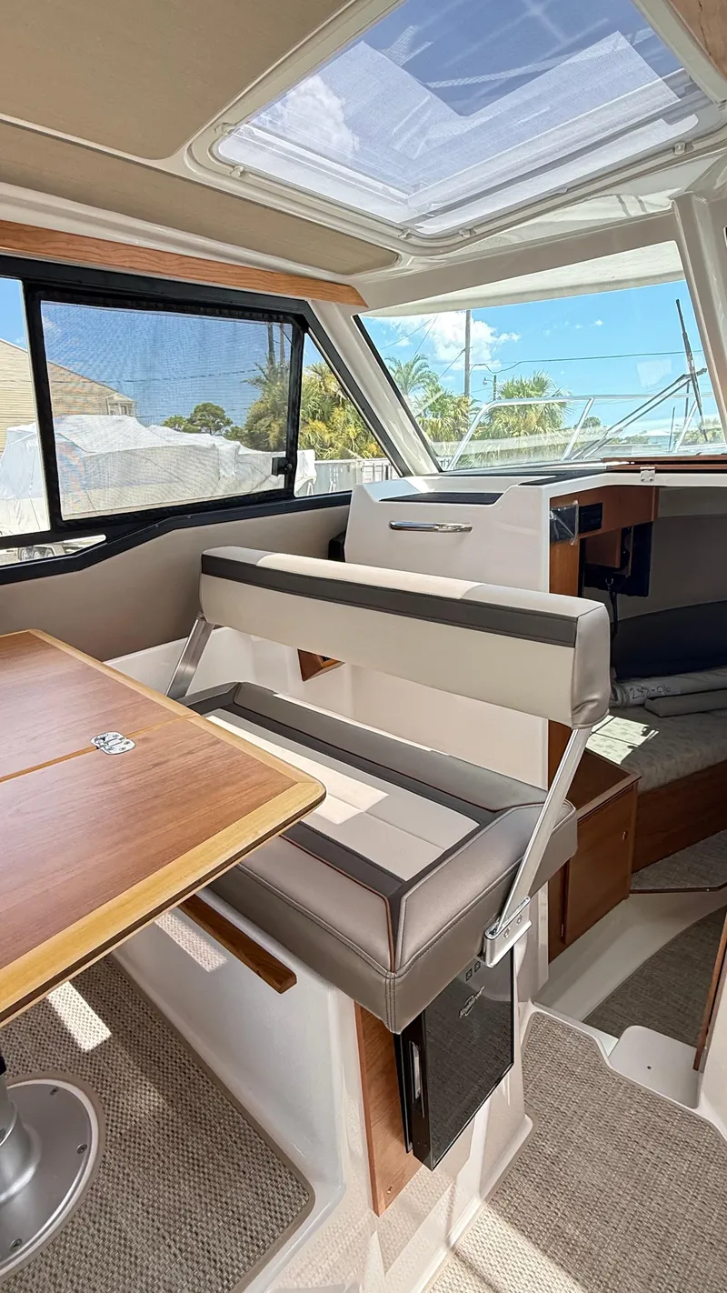 Slide: The Image of 2026 Cutwater C-288 Coupe interior with seating, table, and skylight. - 26