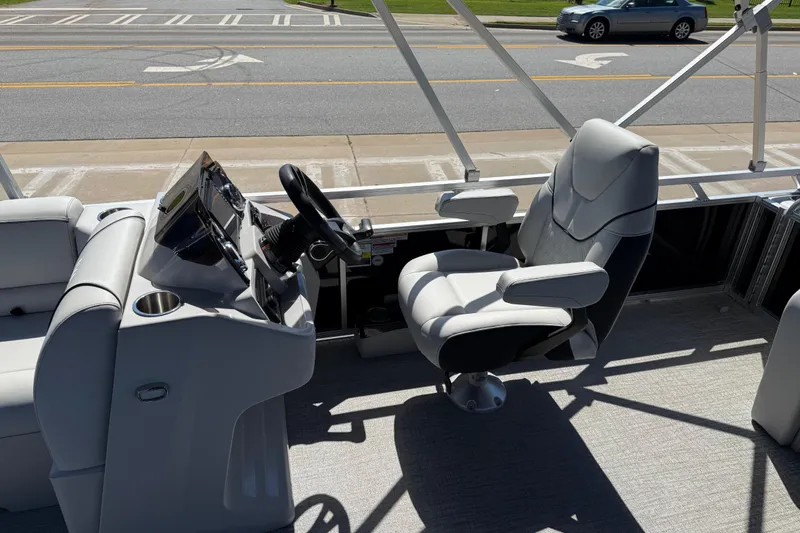 Slide: The Image of 2026 Avalon Venture 85 Versatile rear Bench boat interior with captain's chair and control panel. - 14