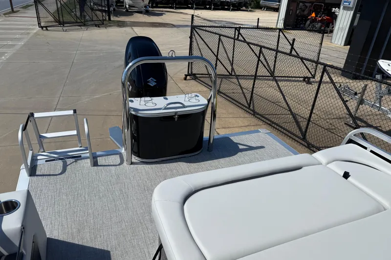 Slide: The Image of 2026 Avalon Venture 85 Versatile rear bench with motor and ladder, docked outdoors. - 29