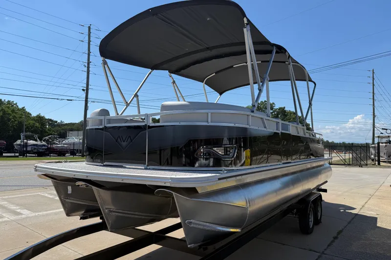 Slide: The Image of 2026 Avalon Venture 85 Versatile Rear Bench pontoon boat on trailer, sunny day. - 3