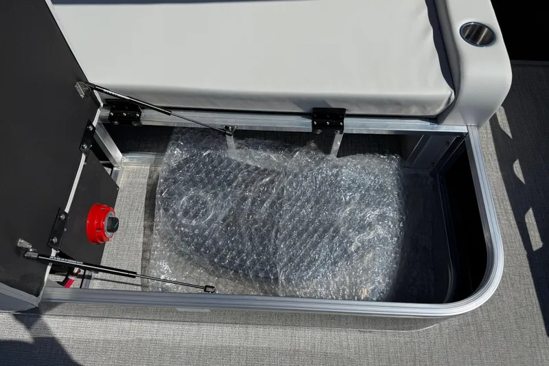 Slide: The Image of Storage compartment of 2026 Avalon Venture 85 Versatile rear bench with bubble-wrapped item. - 39