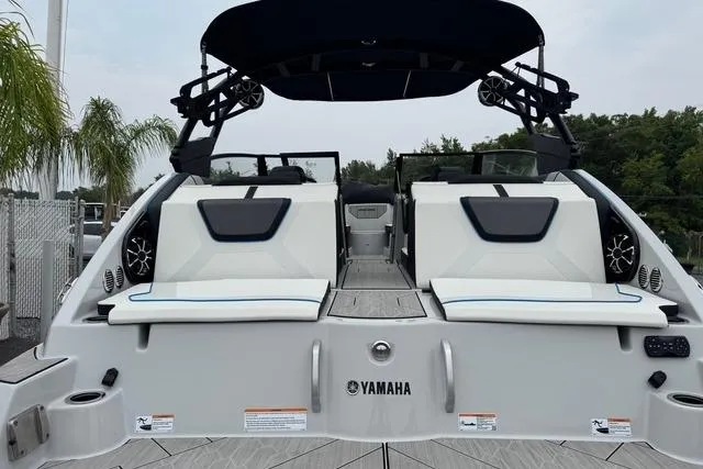 Slide: The Image of 2023 Yamaha Boats 222XD, rear view, showcasing sleek design and spacious seating. - 6
