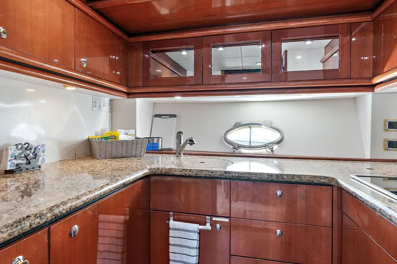 Slide: The Image of Luxurious kitchen interior of 1998 Sunseeker Predator 80 yacht with wooden cabinets and granite countertops. - 15