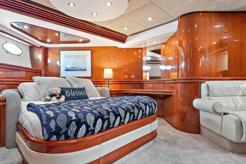 Slide: The Image of Luxurious Sunseeker Predator 80 yacht bedroom with elegant wood paneling and cozy bedding, 1998 model. - 18