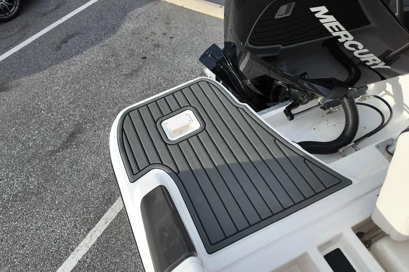 Slide: The Image of 2024 Bayliner TROPHY 22 CX boat with Mercury engine, featuring a sleek deck design. - 12