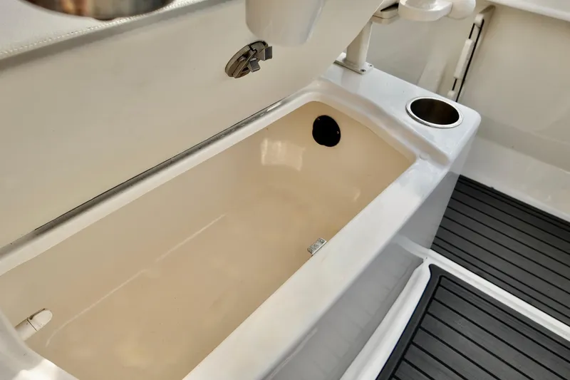 Slide: The Image of 2024 Bayliner TROPHY 22 CX boat interior with storage compartment and cup holder. - 14