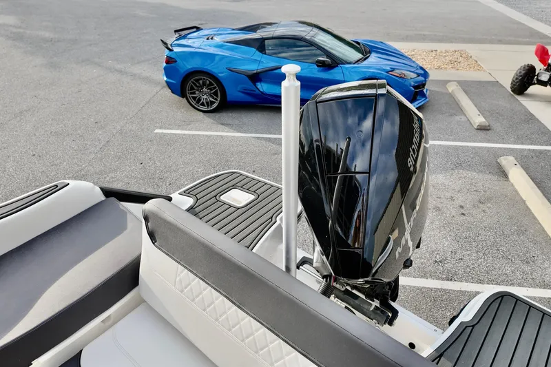 Slide: The Image of 2024 Bayliner TROPHY 22 CX boat with a blue sports car in the background. - 15