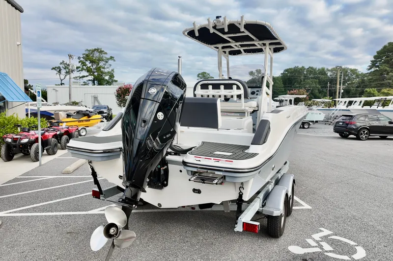 Slide: The Image of 2024 Bayliner TROPHY 22 CX boat on trailer, featuring a powerful outboard motor. - 3