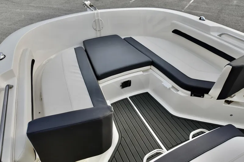 Slide: The Image of 2024 Bayliner TROPHY 22 CX boat interior with cushioned seating and sleek design. - 6