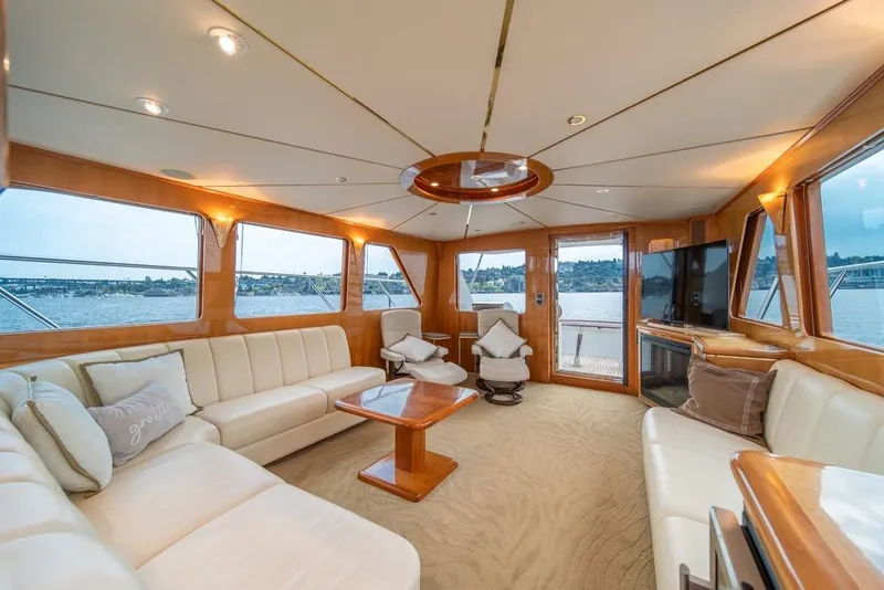 Slide: The Image of Luxurious interior of 2005 Ocean Alexander 64 Motoryacht with elegant seating and panoramic windows. - 12