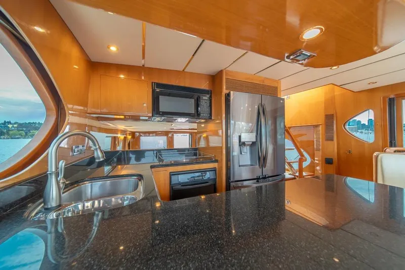 Slide: The Image of Luxurious kitchen interior of 2005 Ocean Alexander 64 Motoryacht with modern appliances and wood finish. - 19