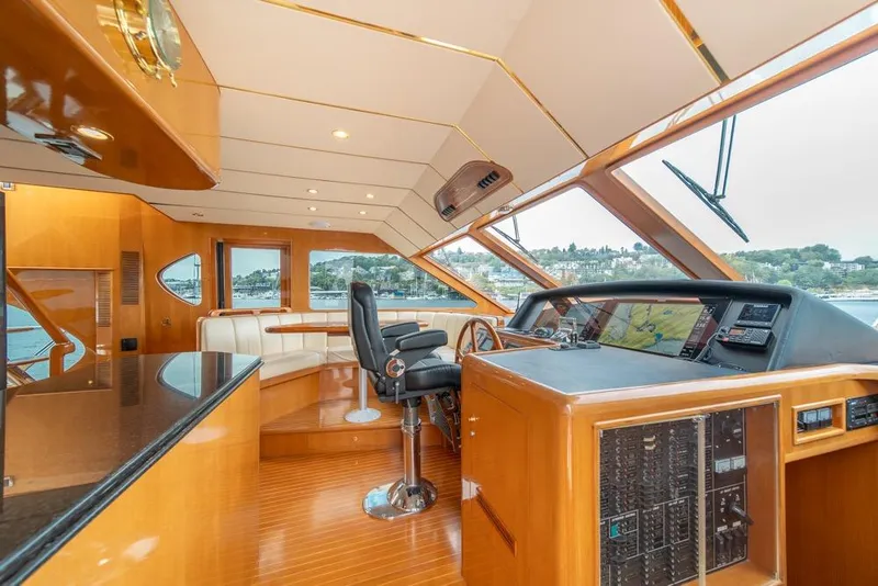 Slide: The Image of Luxurious 2005 Ocean Alexander 64 Motoryacht helm with panoramic windows and elegant wood finish. - 21
