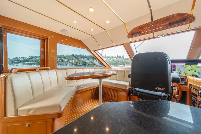 Slide: The Image of Luxurious interior of 2005 Ocean Alexander 64 Motoryacht with plush seating and panoramic windows. - 22