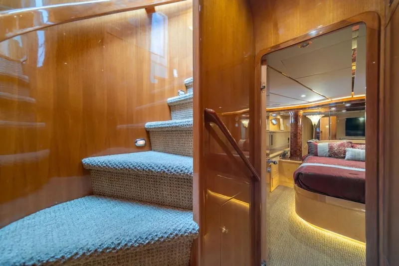Slide: The Image of Luxurious interior of 2005 Ocean Alexander 64 Motoryacht with elegant staircase and cozy bedroom. - 24