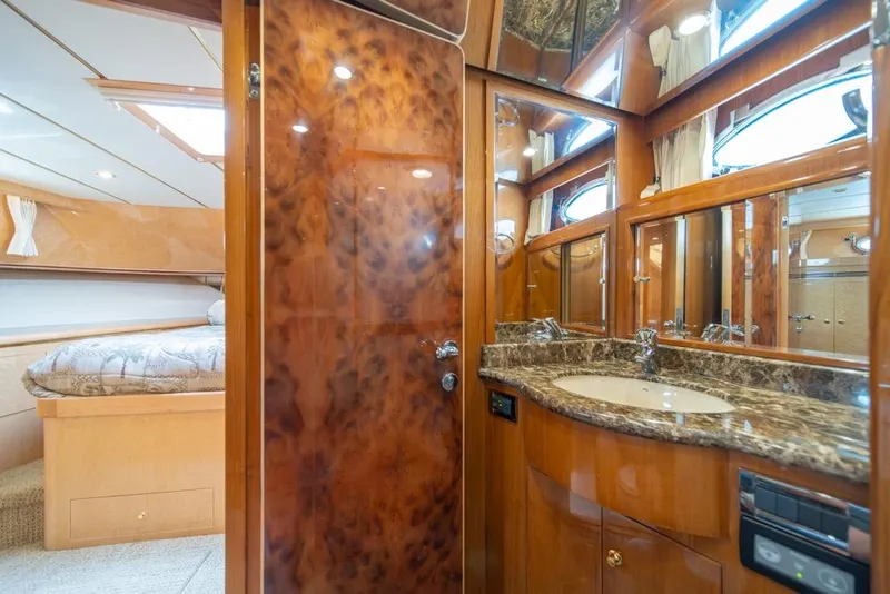 Slide: The Image of Luxurious bathroom and bedroom interior of 2005 Ocean Alexander 64 Motoryacht, featuring wood finishes. - 34