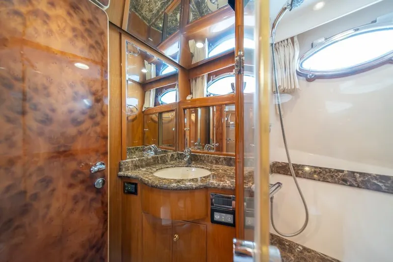 Slide: The Image of Luxurious bathroom in 2005 Ocean Alexander 64 Motoryacht with marble countertop and wood accents. - 35