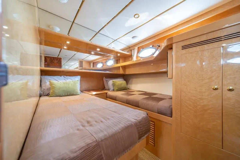 Slide: The Image of Luxurious 2005 Ocean Alexander 64 Motoryacht cabin with twin beds and elegant wood finish. - 36