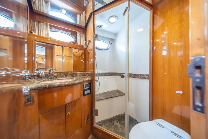 Slide: The Image of Luxurious bathroom in 2005 Ocean Alexander 64 Motoryacht with wood accents and marble surfaces. - 39
