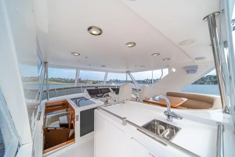 Slide: The Image of Luxurious 2005 Ocean Alexander 64 Motoryacht interior with helm, seating, and sink. - 40