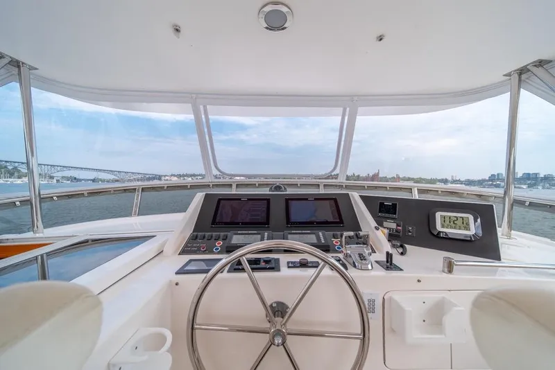 Slide: The Image of 2005 Ocean Alexander 64 Motoryacht helm with navigation controls and panoramic water view. - 42