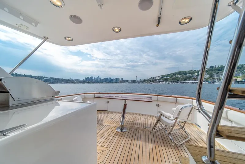Slide: The Image of 2005 Ocean Alexander 64 Motoryacht deck with city skyline view, featuring seating and grill. - 45