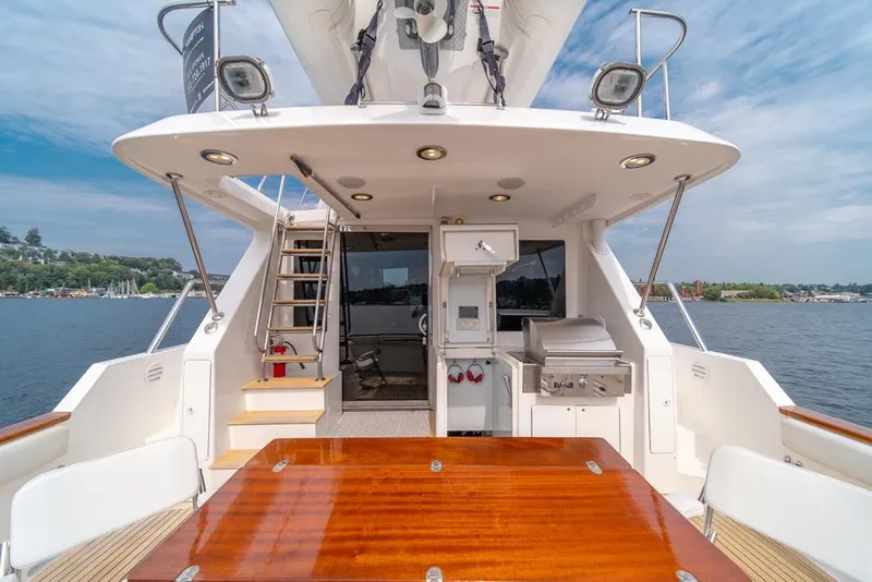 Slide: The Image of 2005 Ocean Alexander 64 Motoryacht aft deck with dining table and outdoor kitchen. - 53