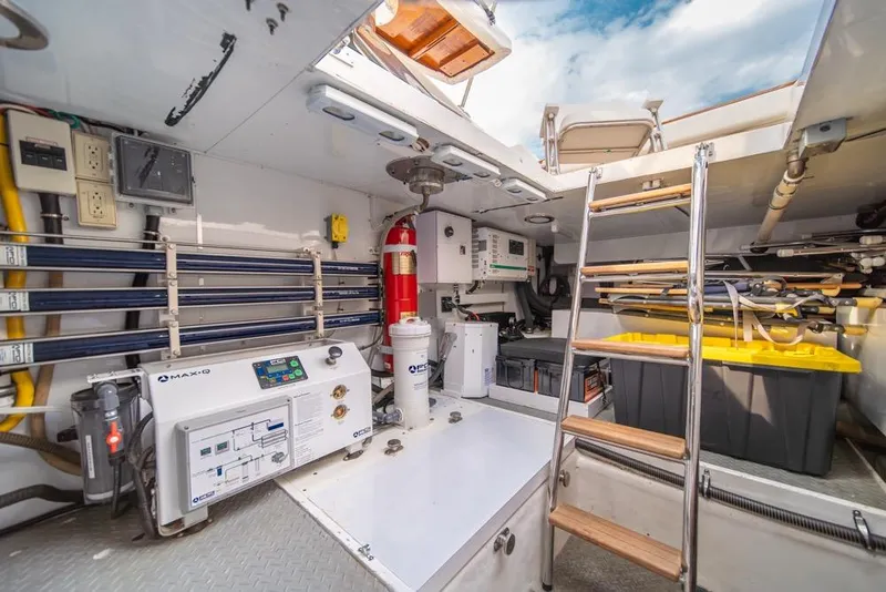 Slide: The Image of Engine room of 2005 Ocean Alexander 64 Motoryacht with equipment and storage. - 54